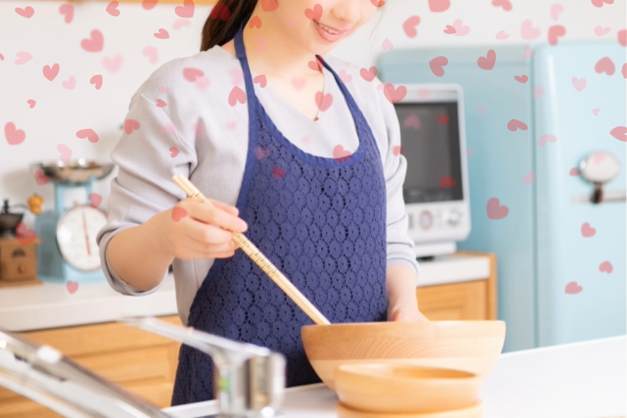 ハートに囲まれて料理する女性